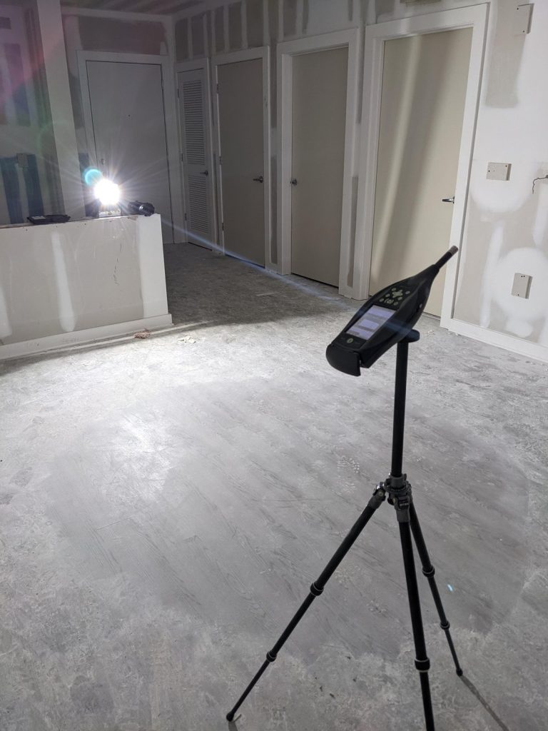 Building acoustics testing with sound analyzer in an unfinished interior